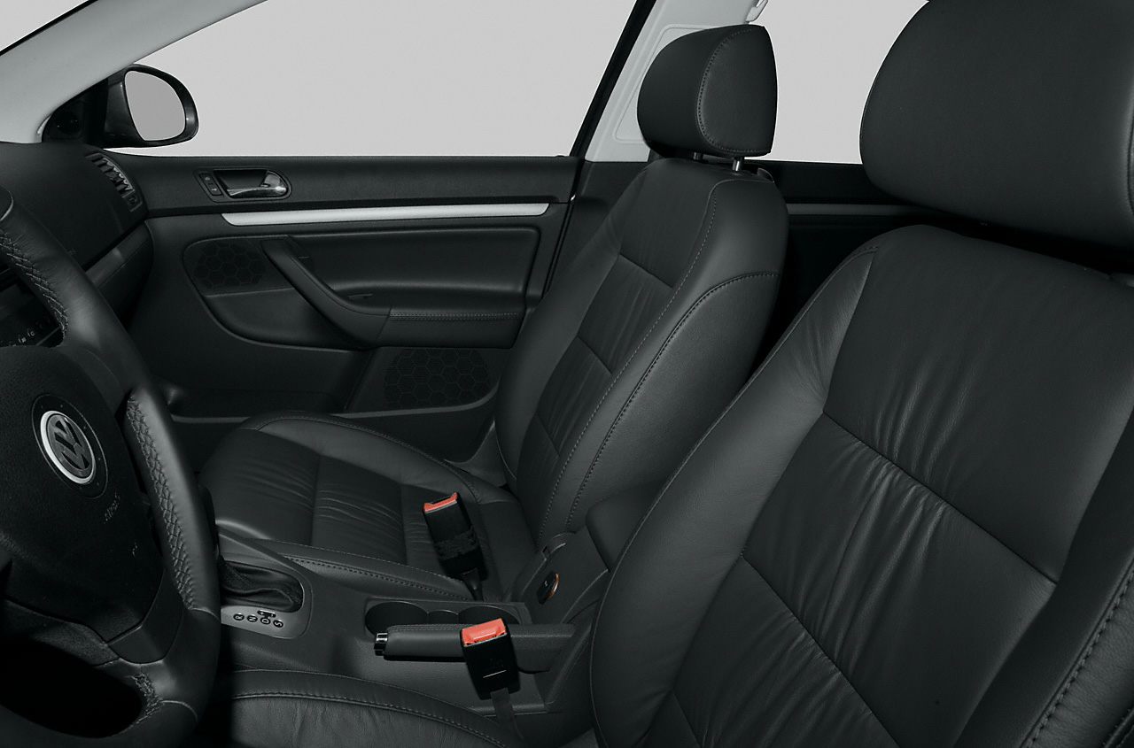Black leather front seats and detailed dashboard with door panel