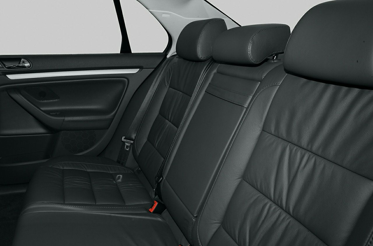 Black leather rear seats with headrests and door panel in a sedan