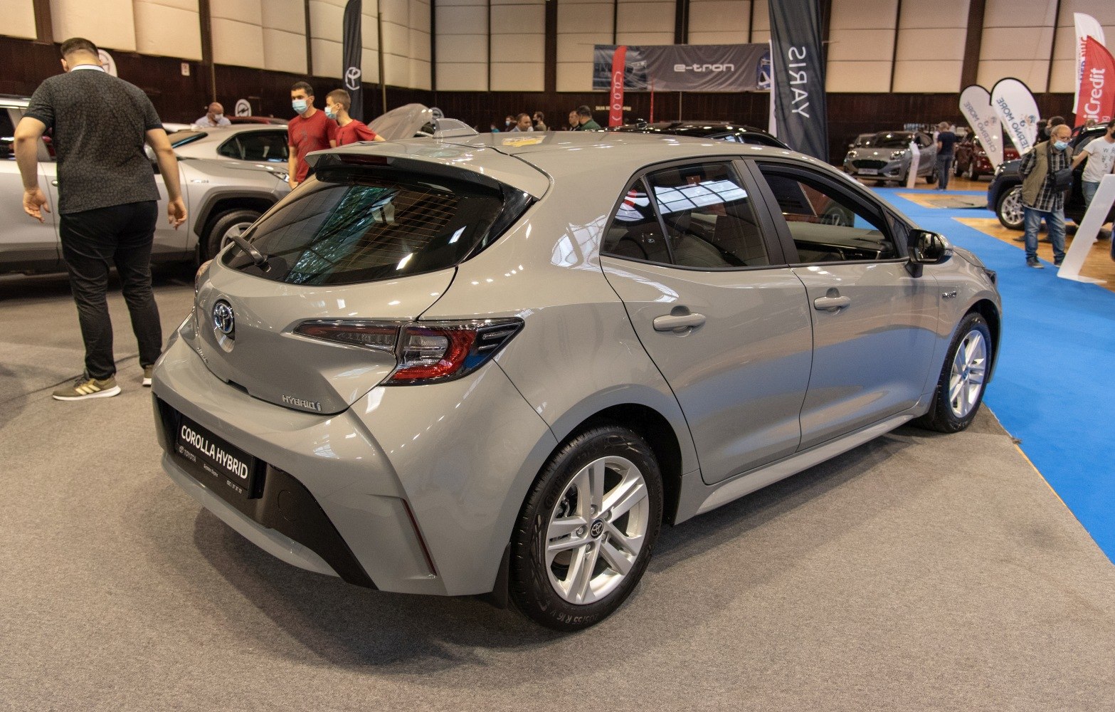 Rear-side view of a modern hybrid hatchback with sleek LED tail lights.