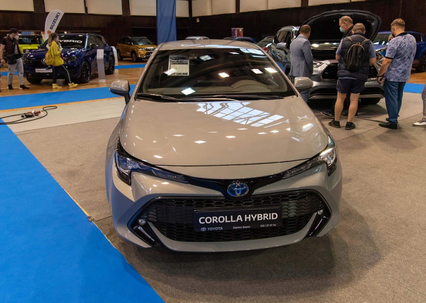 Front view of a compact hybrid hatchback with grille and sleek headlights