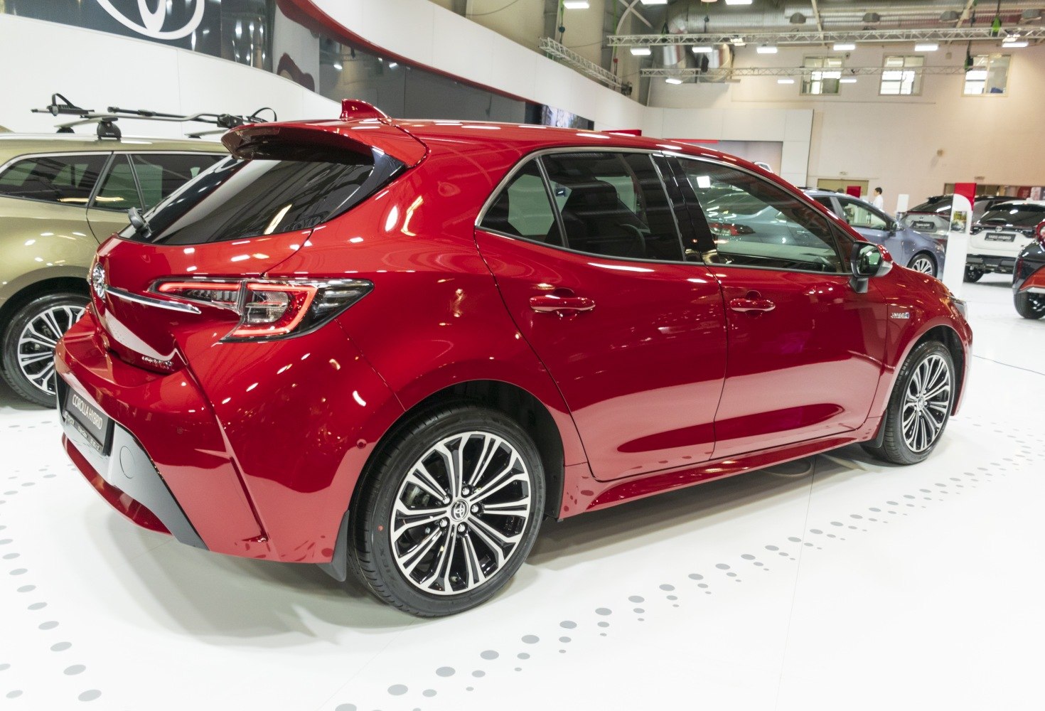 Red hatchback rear side view with alloy wheels and sporty design