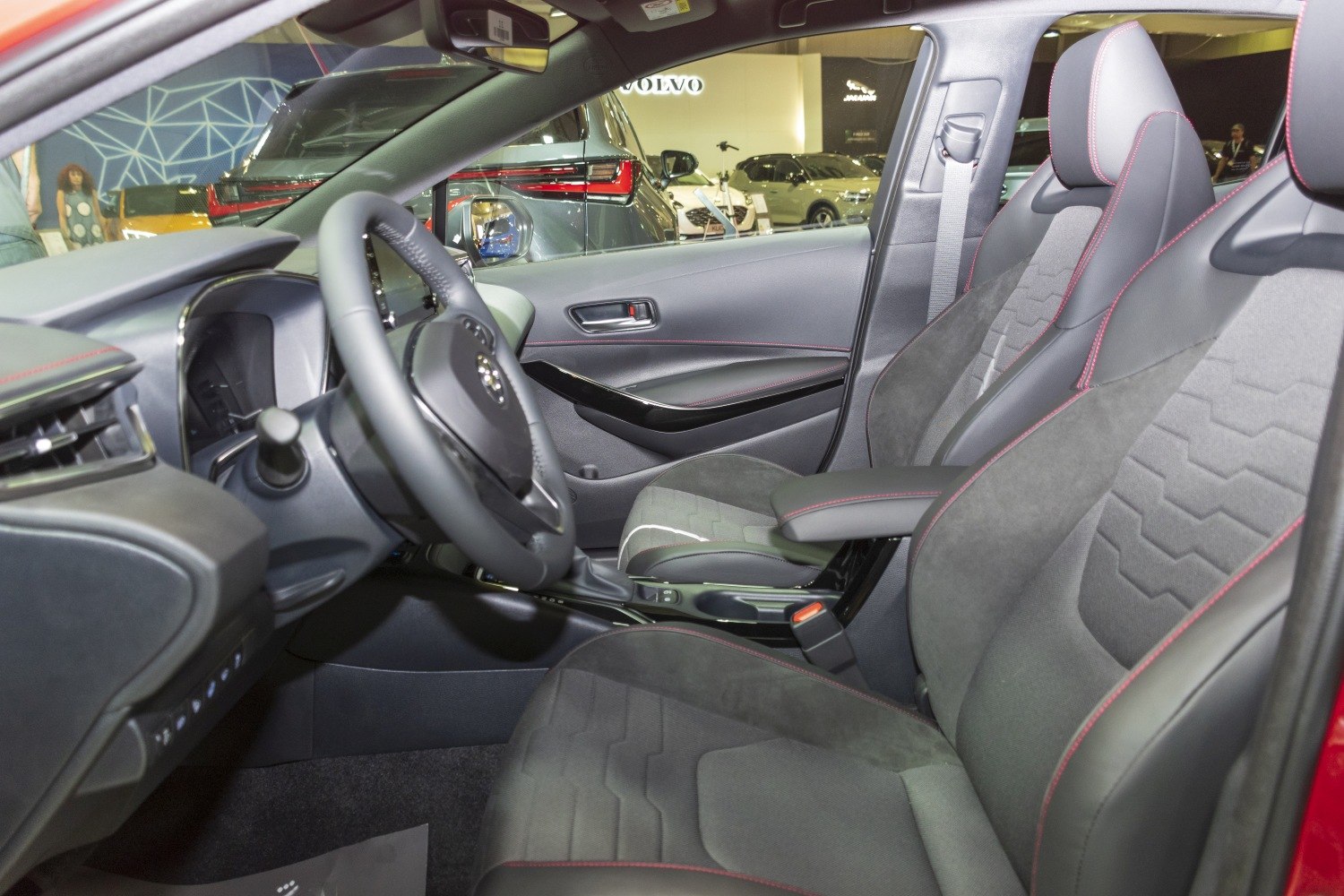 Car interior with red stitching seats and ergonomic layout