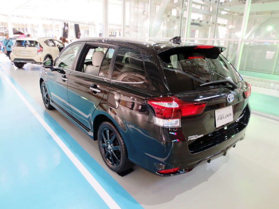 Rear and side view of black station wagon with tinted windows and sport wheels
