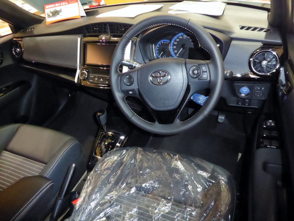 Interior view of dashboard, steering wheel, and center console with automatic shifter