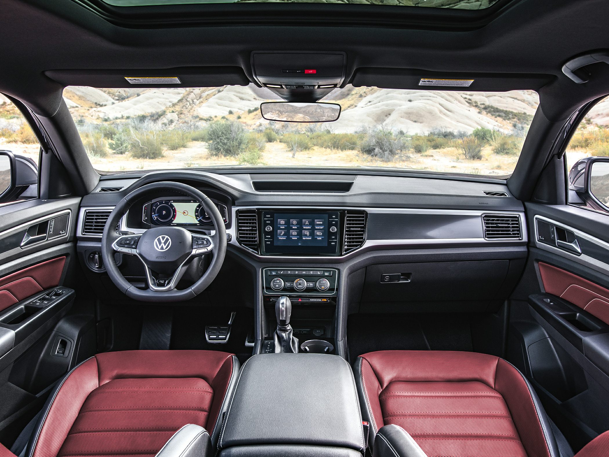 Interior with red leather seats, digital dashboard, panoramic sunroof