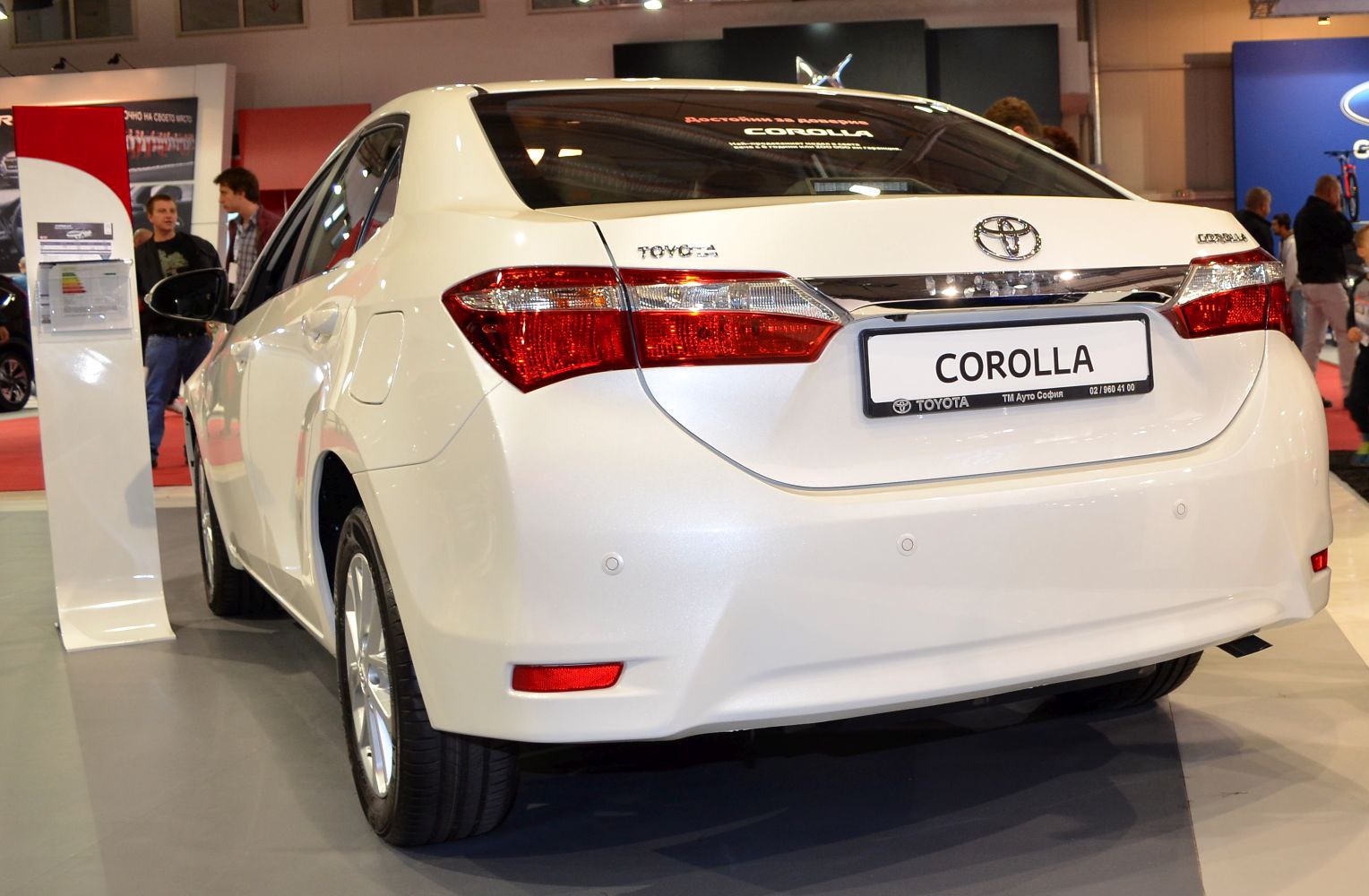 Rear view of white sedan focusing on taillights and bumper