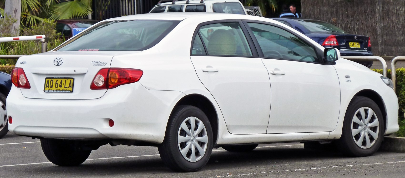 Rear view of white sedan with distinctive taillights and trunk shape