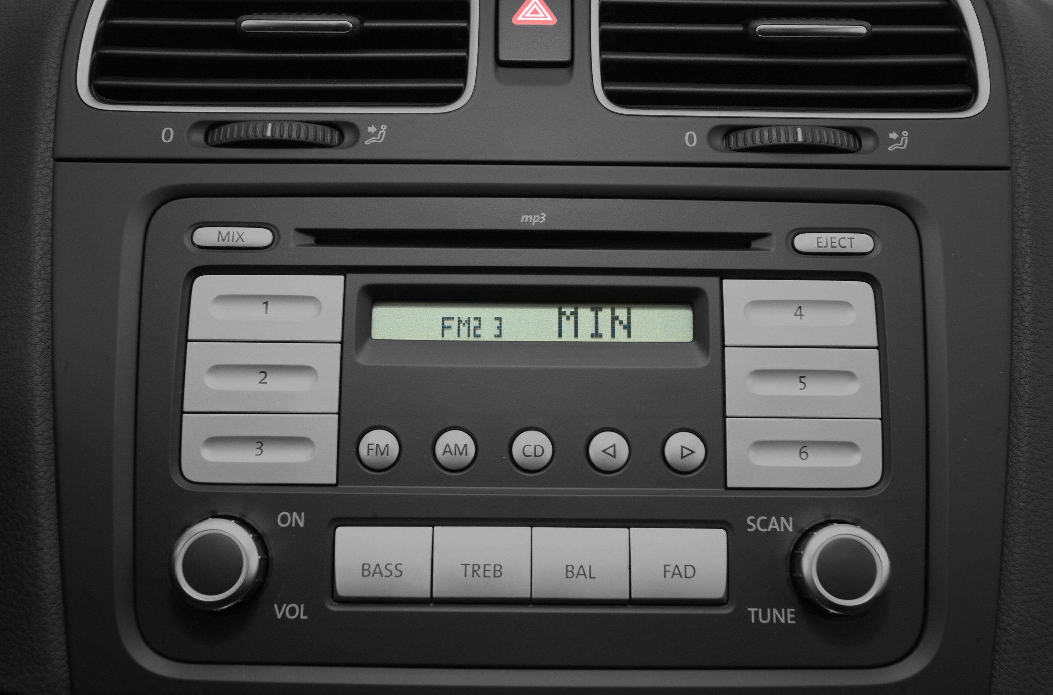 Car stereo system with radio display and air vents with control knobs
