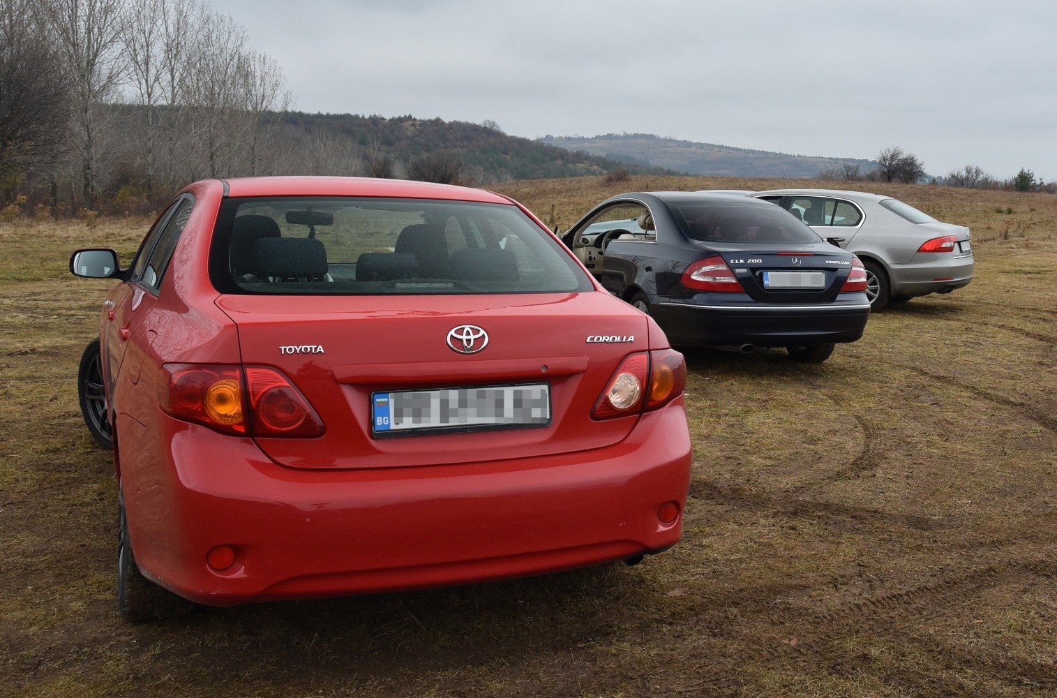 Rear view of red compact sedan with distinctive taillight design