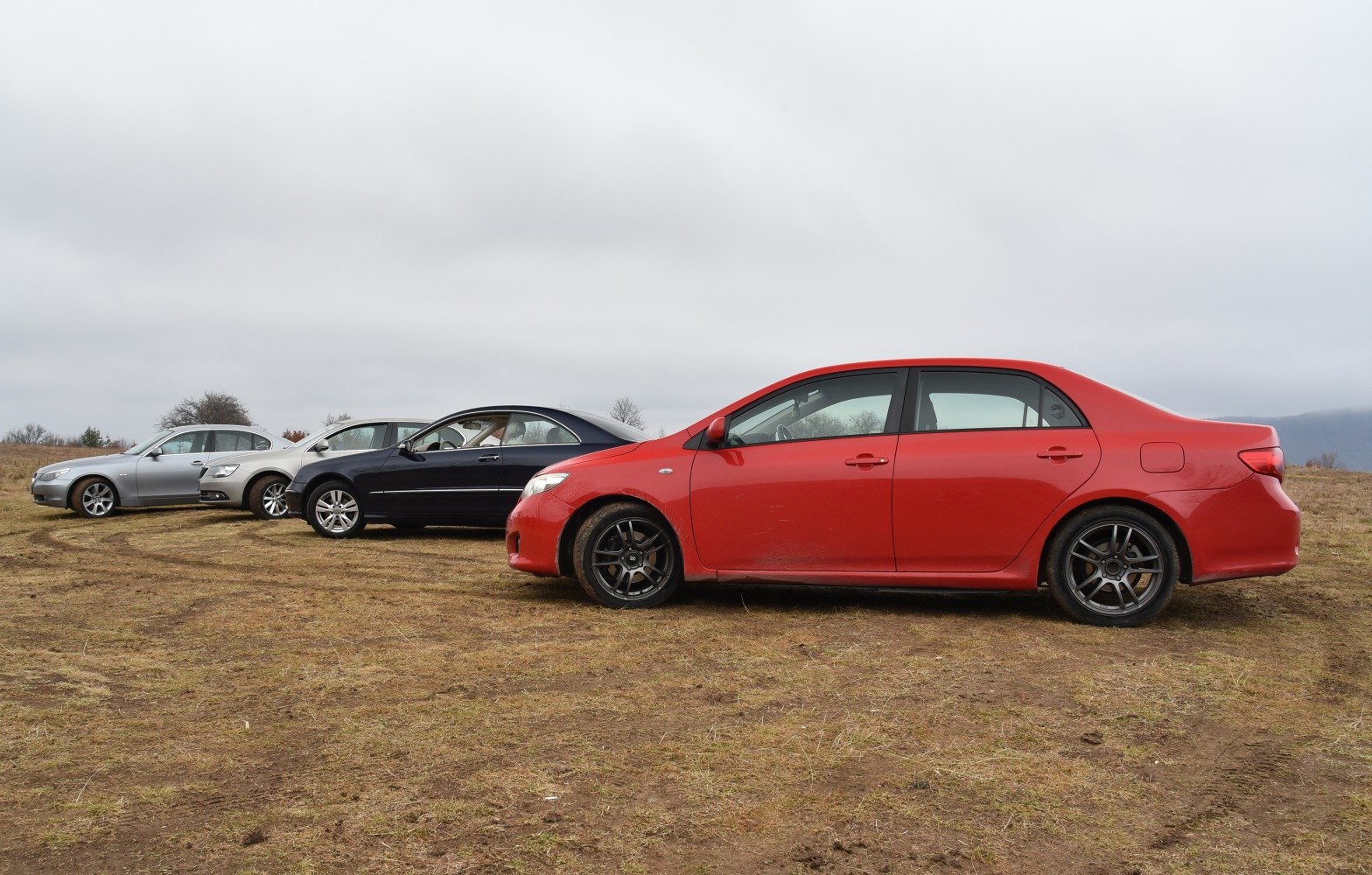Side profile of a mid-size sedan with alloy wheels and four doors