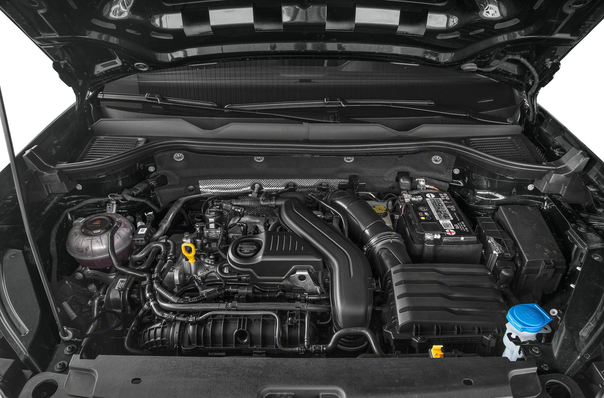 Close-up of compact modern engine bay with visible components and fluid reservoirs