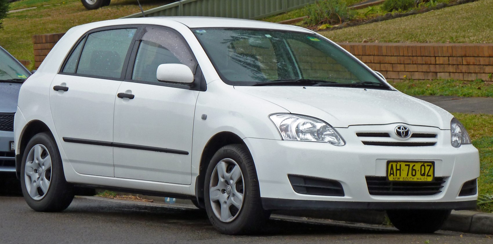 White hatchback, front side view, alloy wheels