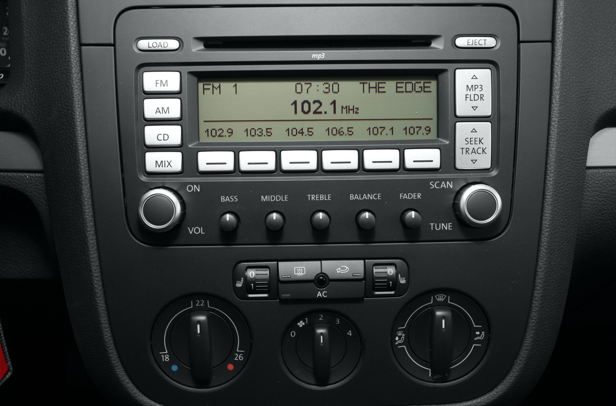 Car radio and climate control panel with knobs and buttons