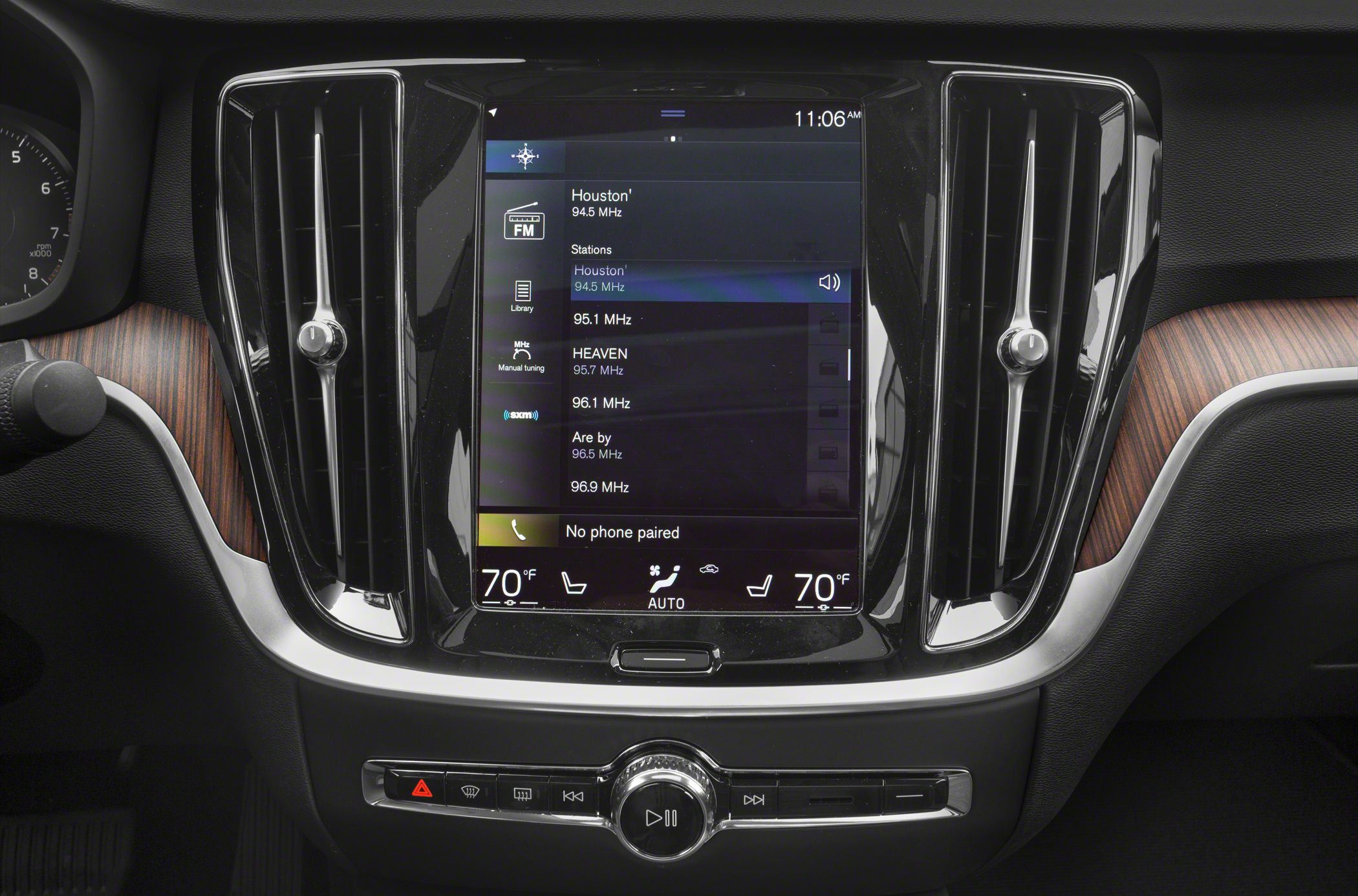 Touchscreen infotainment and dual-zone climate control panel with air vents and wood trim