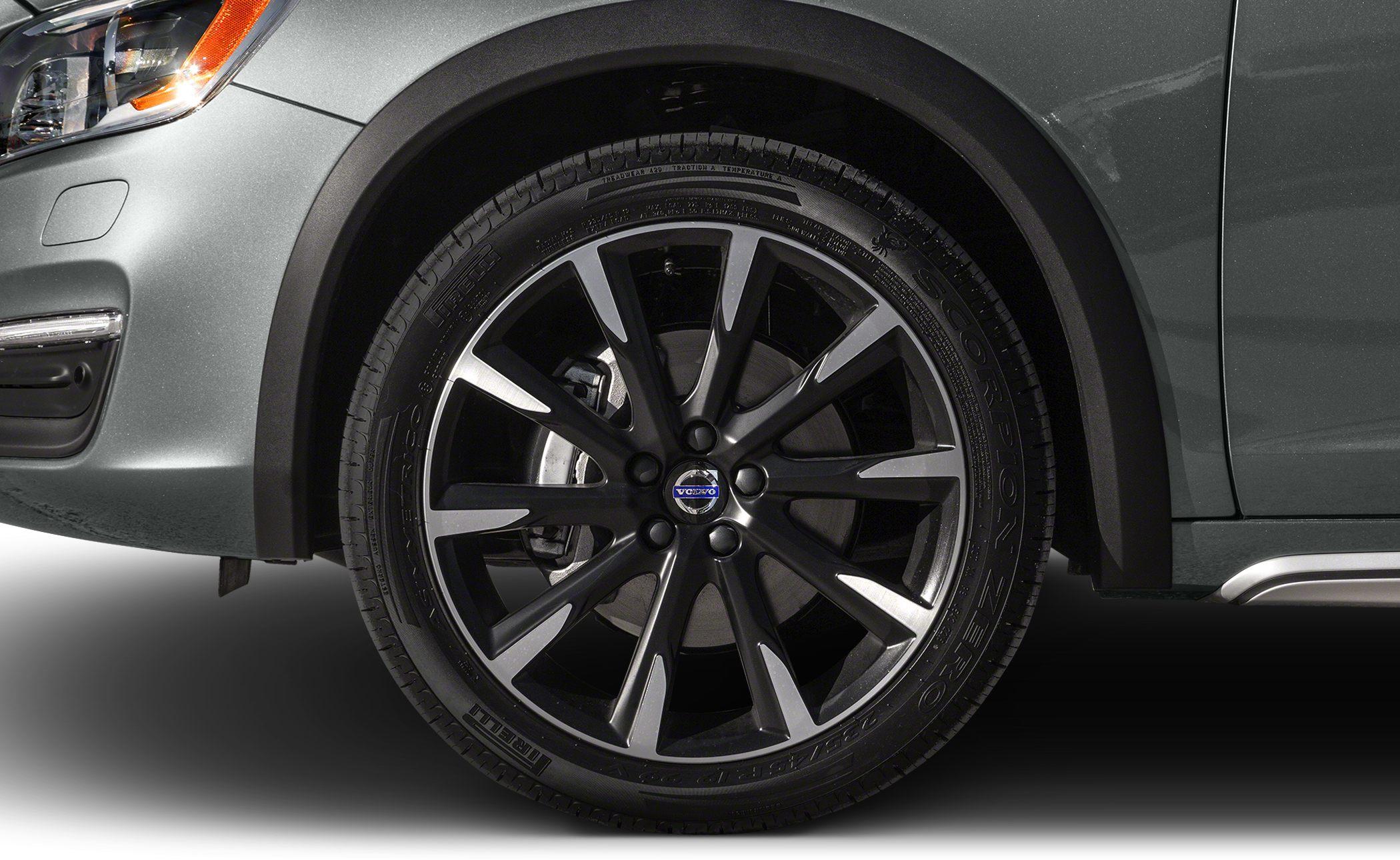 Close-up of alloy wheel and tire on vehicle front side.