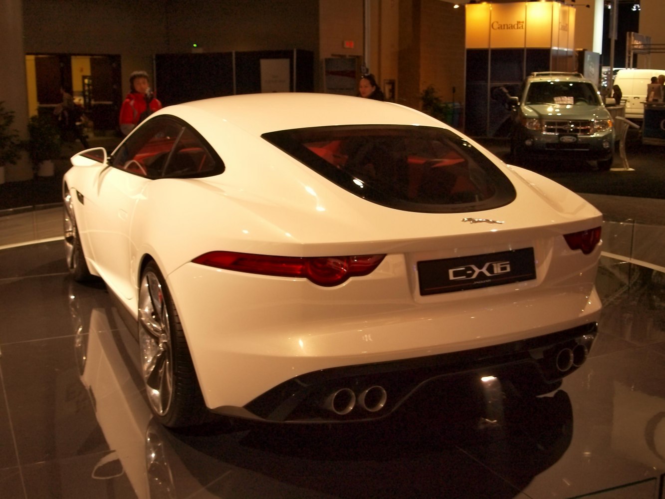 Sporty coupe rear with quad exhausts and sleek taillights