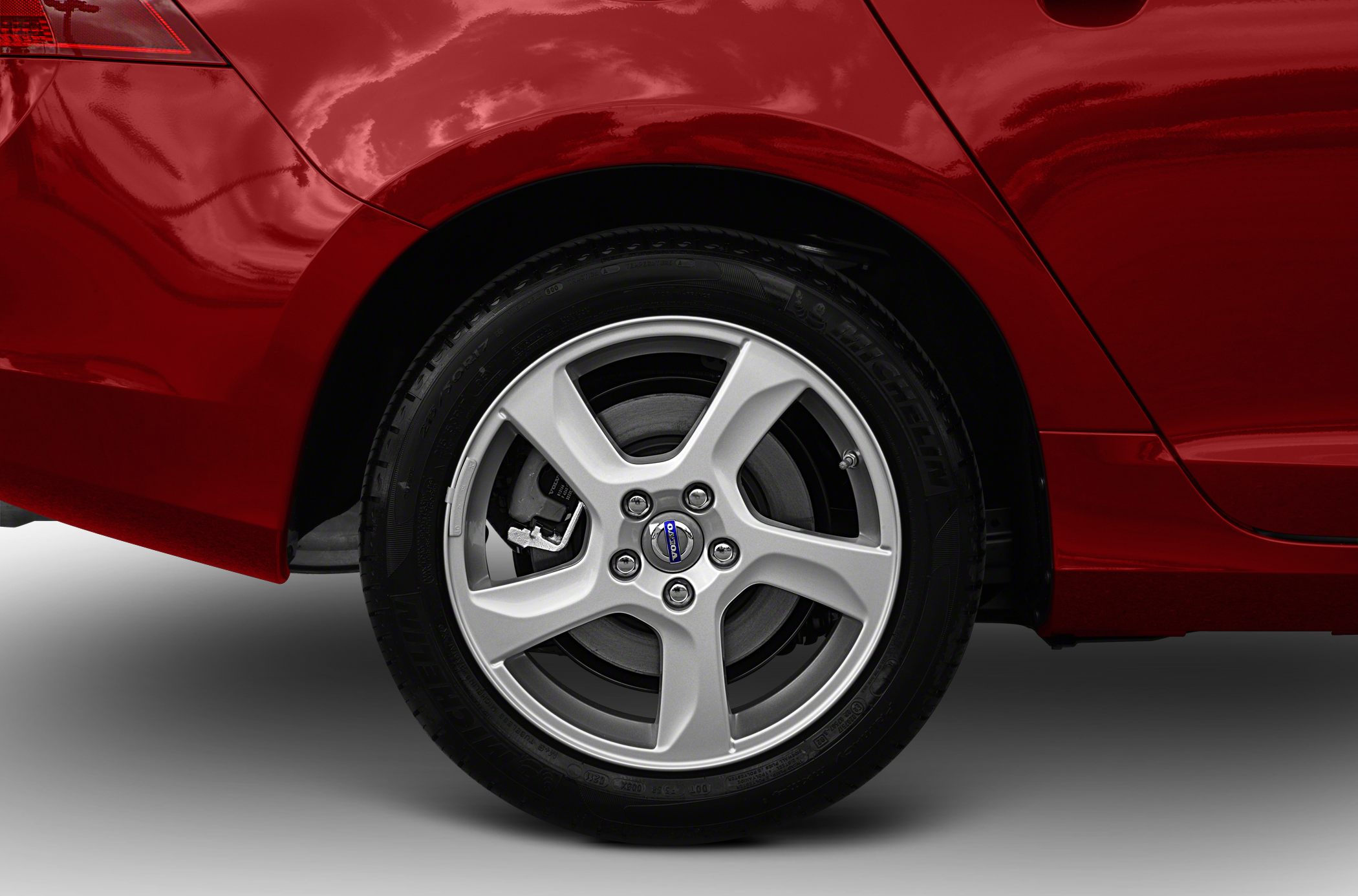 Alloy wheel and rear quarter panel of red car