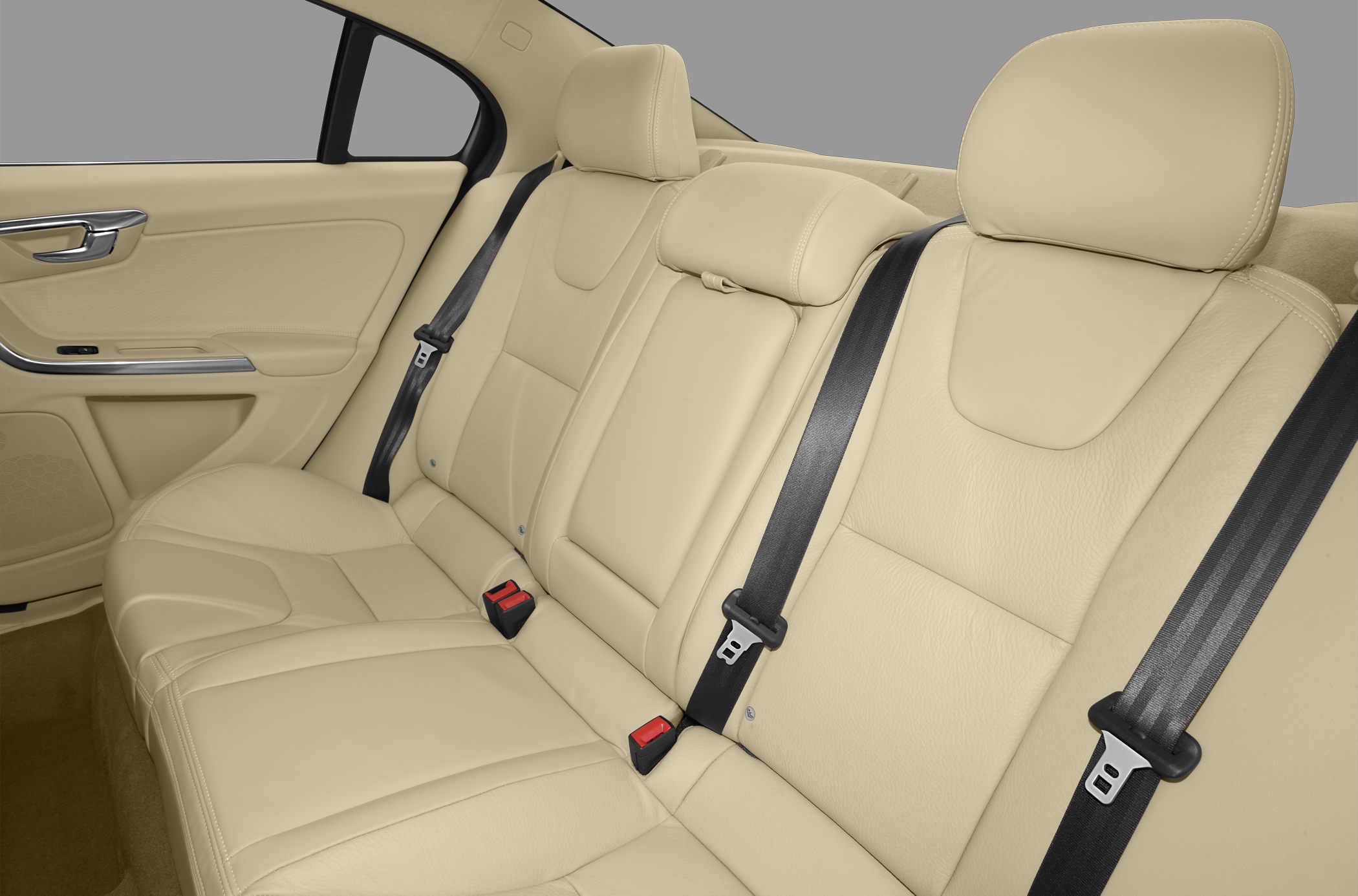 Beige leather rear seats with black seatbelts and headrests