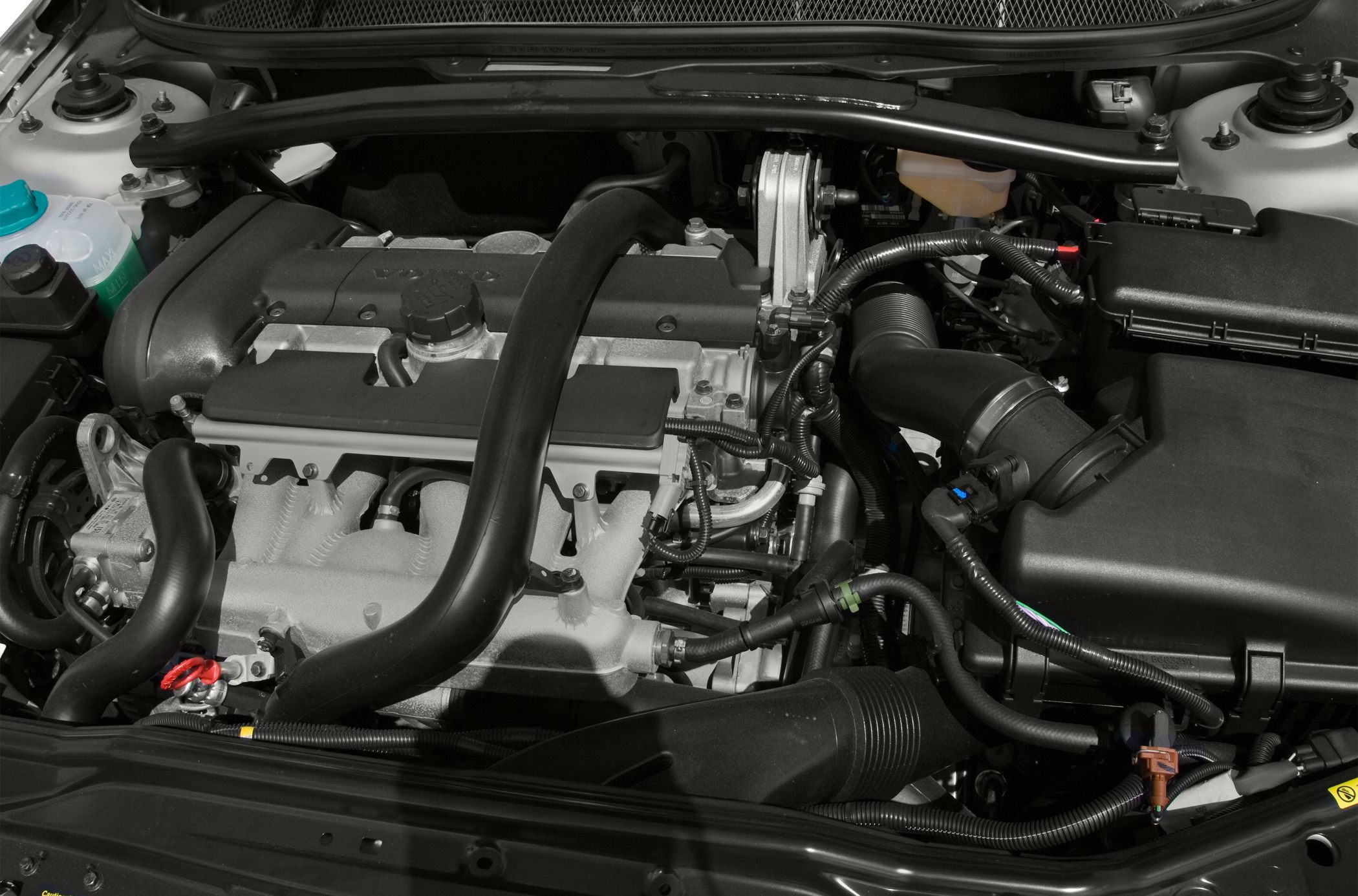 Engine compartment with detailed view of hoses and components