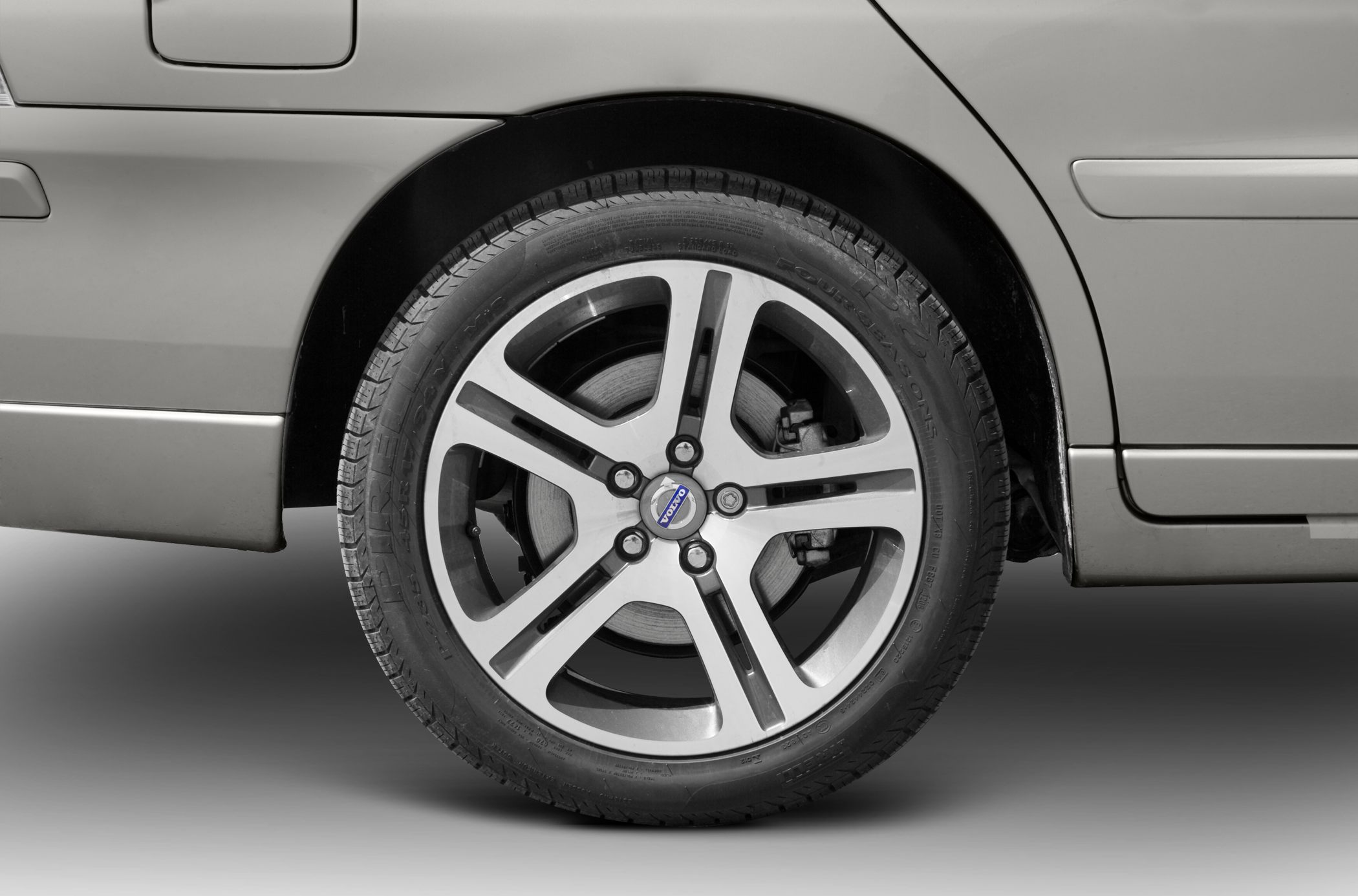 Close-up of an alloy wheel and rear side panel of a vehicle
