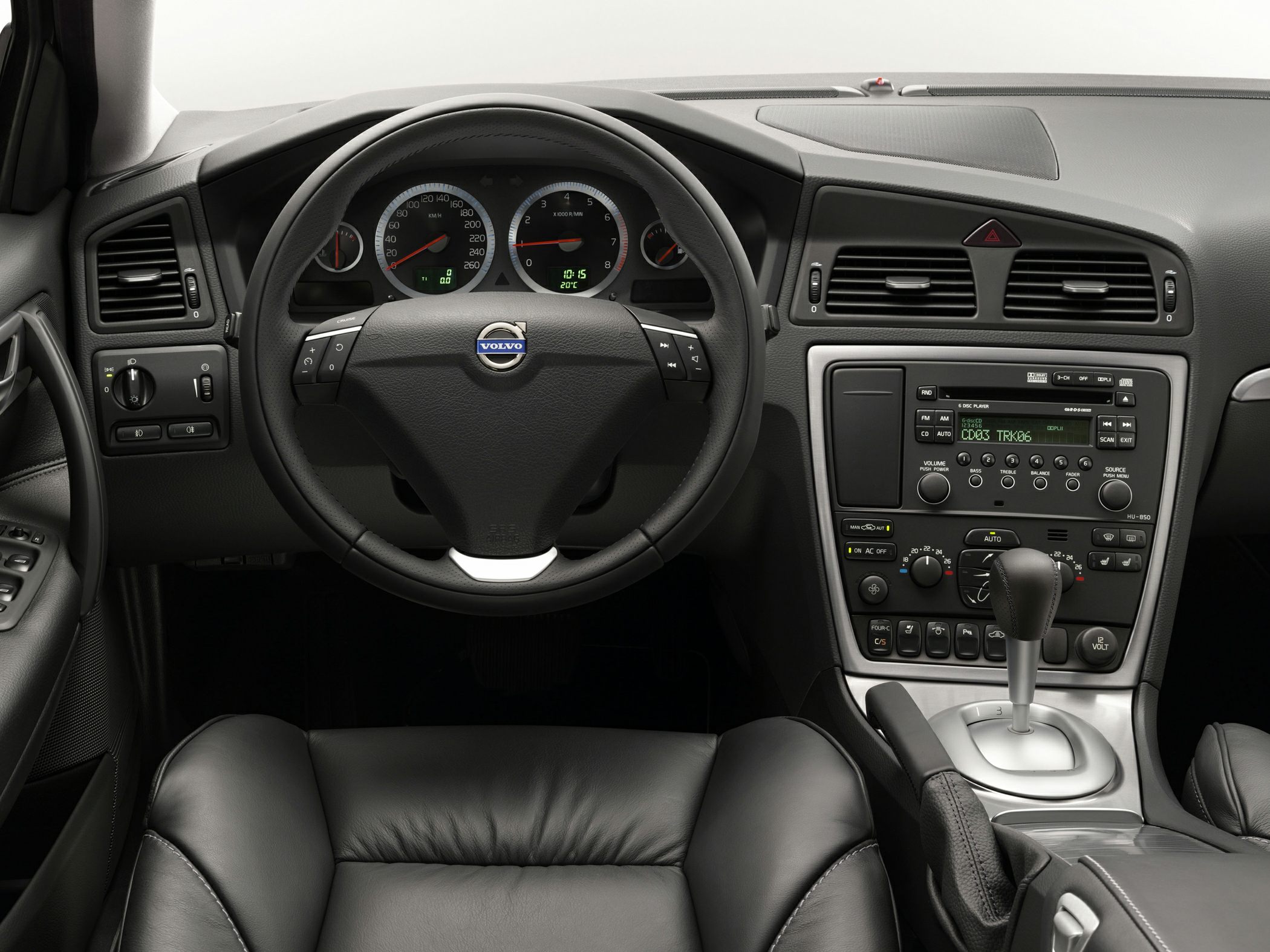 Car dashboard with steering wheel, instrument cluster, and center console.