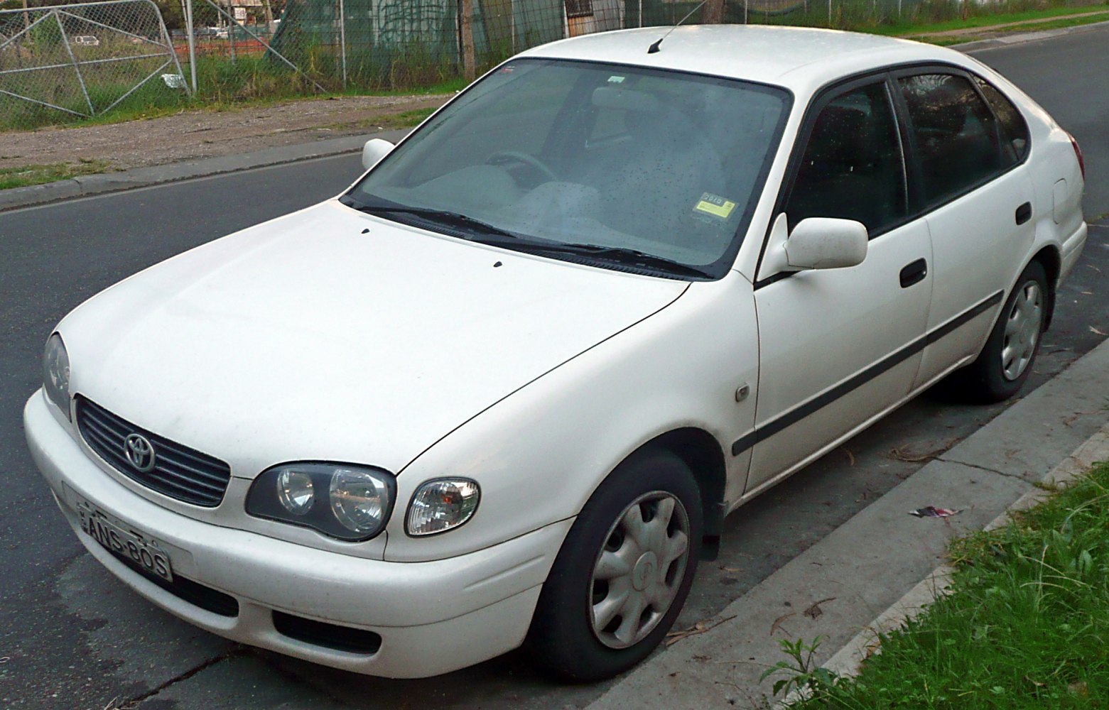White hatchback with rounded headlights and compact 4-door design