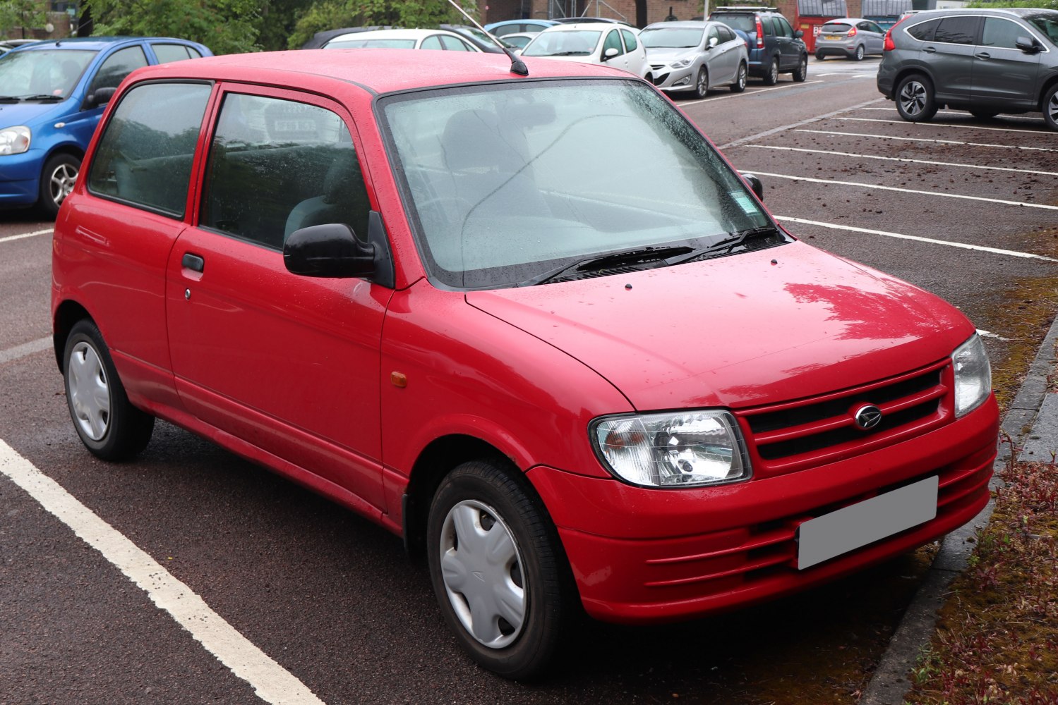Compact hatchback with rounded rectangular headlights and simple grille