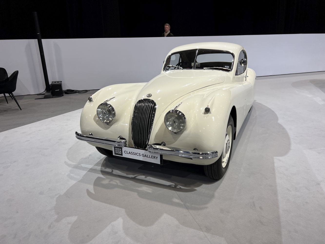 Front view of classic car with rounded headlights and streamlined body