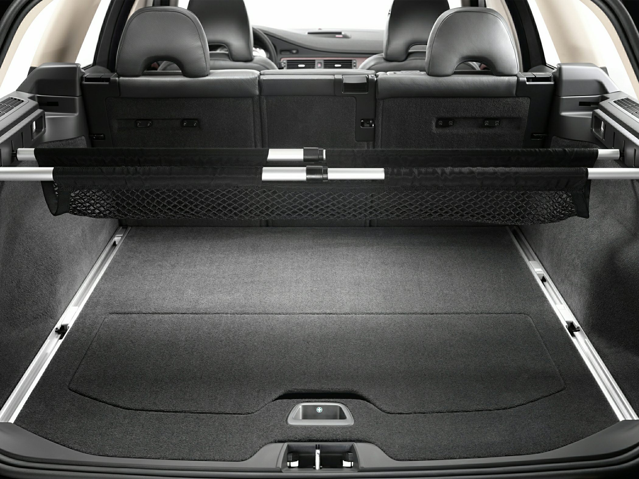 Car interior with carpeted cargo floor and adjustable load divider net
