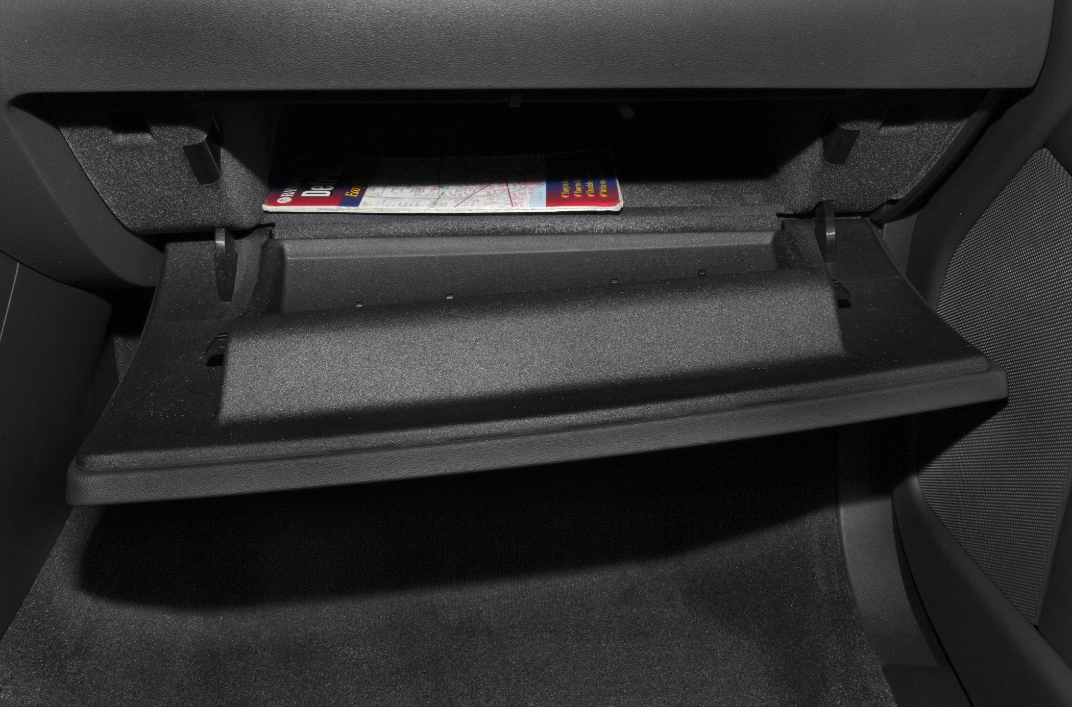 Open glove compartment with map inside