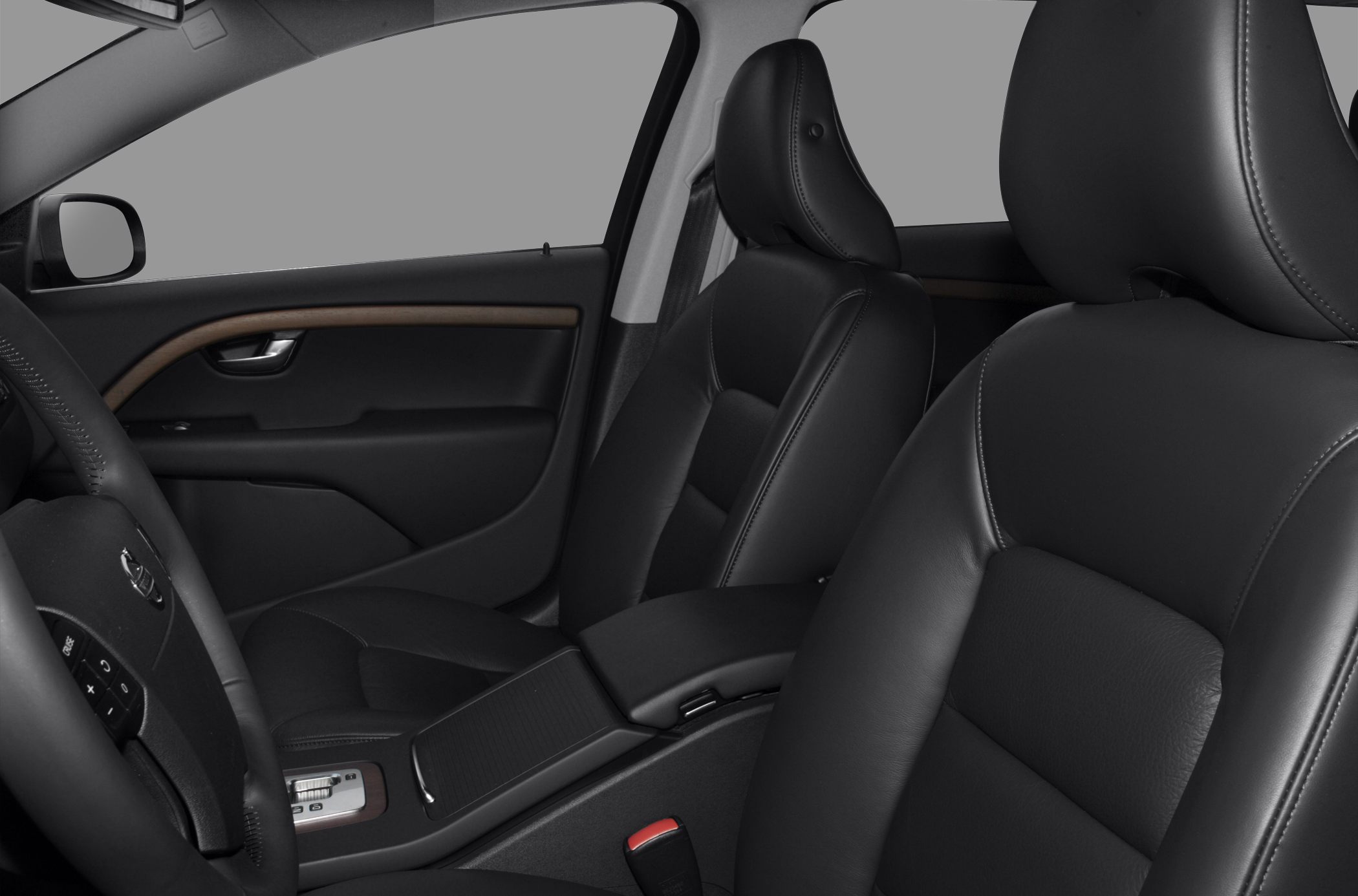 Black leather seats with detailed stitching and wood trim on door panel