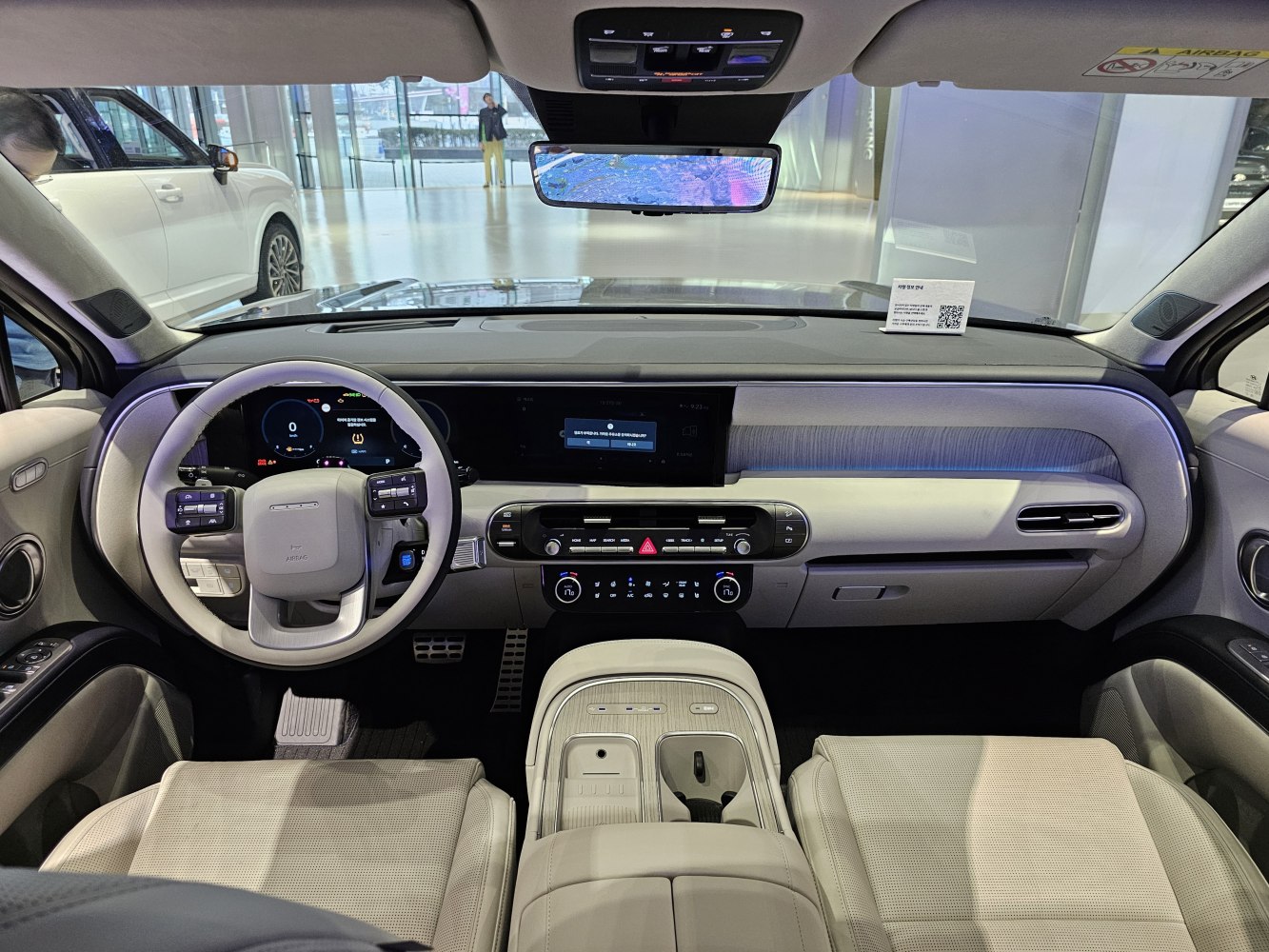 Digital dashboard and multifunction steering wheel with beige upholstery.