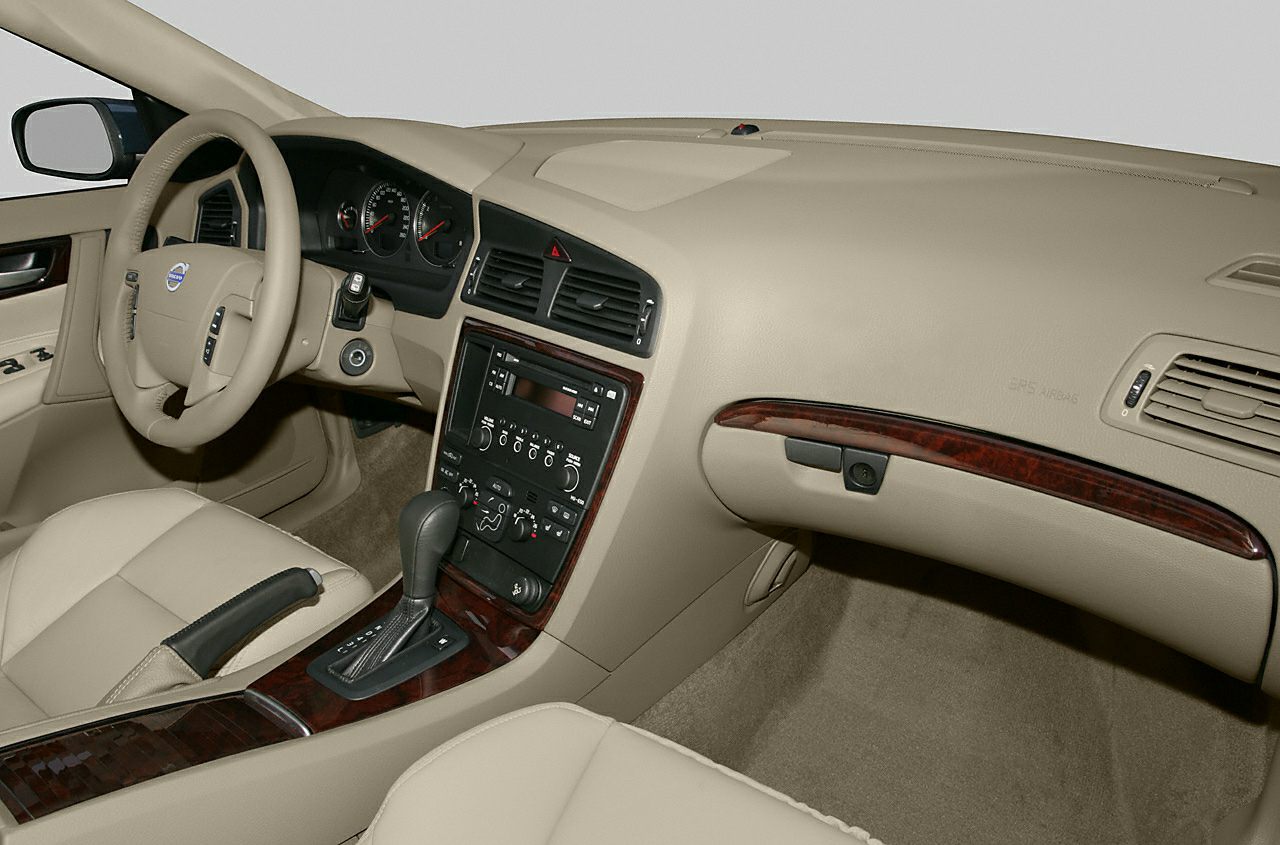 Beige dashboard with wood trim and center console in car interior
