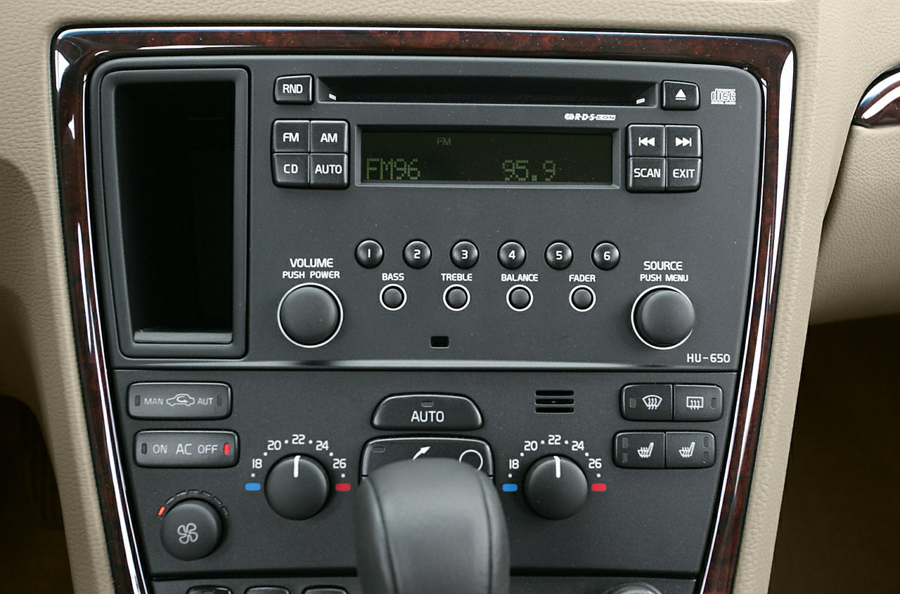 Audio system and climate control panel with wood trim and multiple control buttons