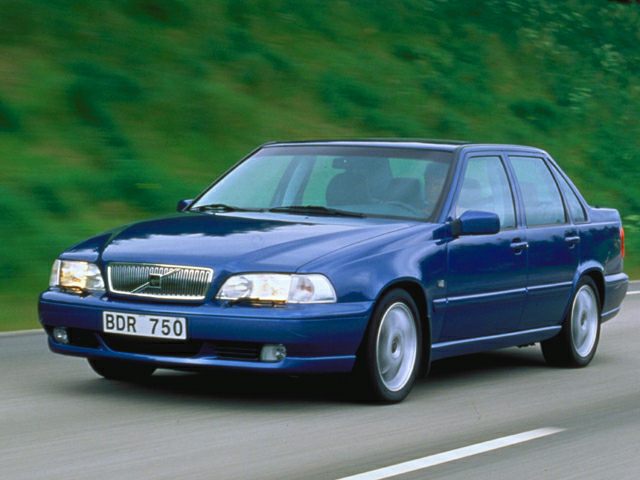 Front side view of 1990s four-door sedan in blue on road