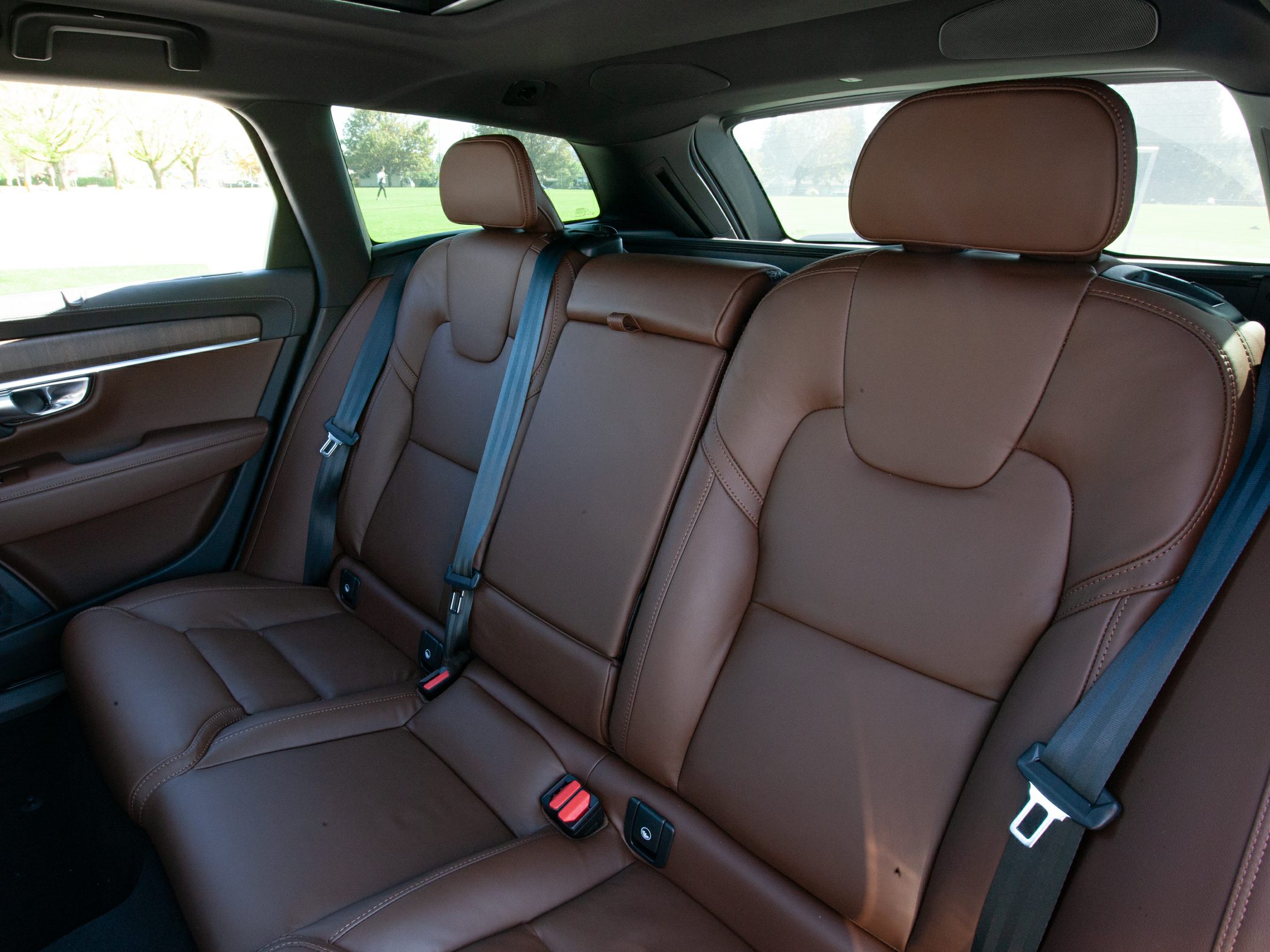 Rear brown leather seats with seat belts and stitched design