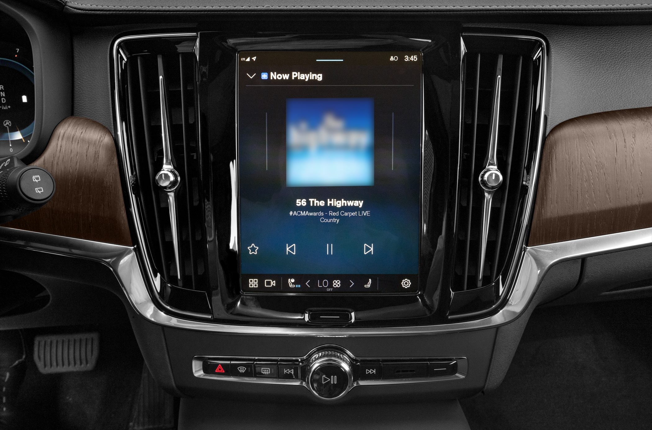 Touchscreen infotainment and climate control panel with wood trim and vents.