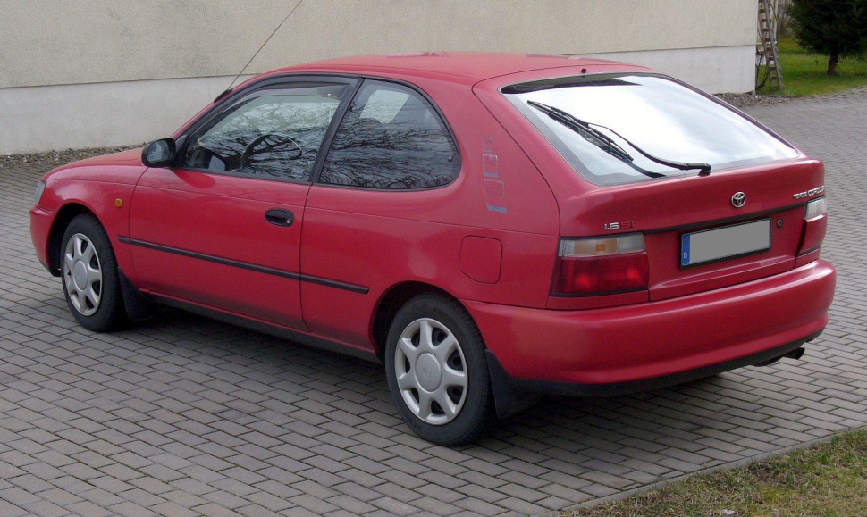 Red hatchback with distinctive rear design and side profile.