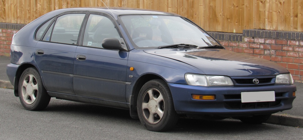 Blue 5-door hatchback with rectangular headlights and alloy wheels.