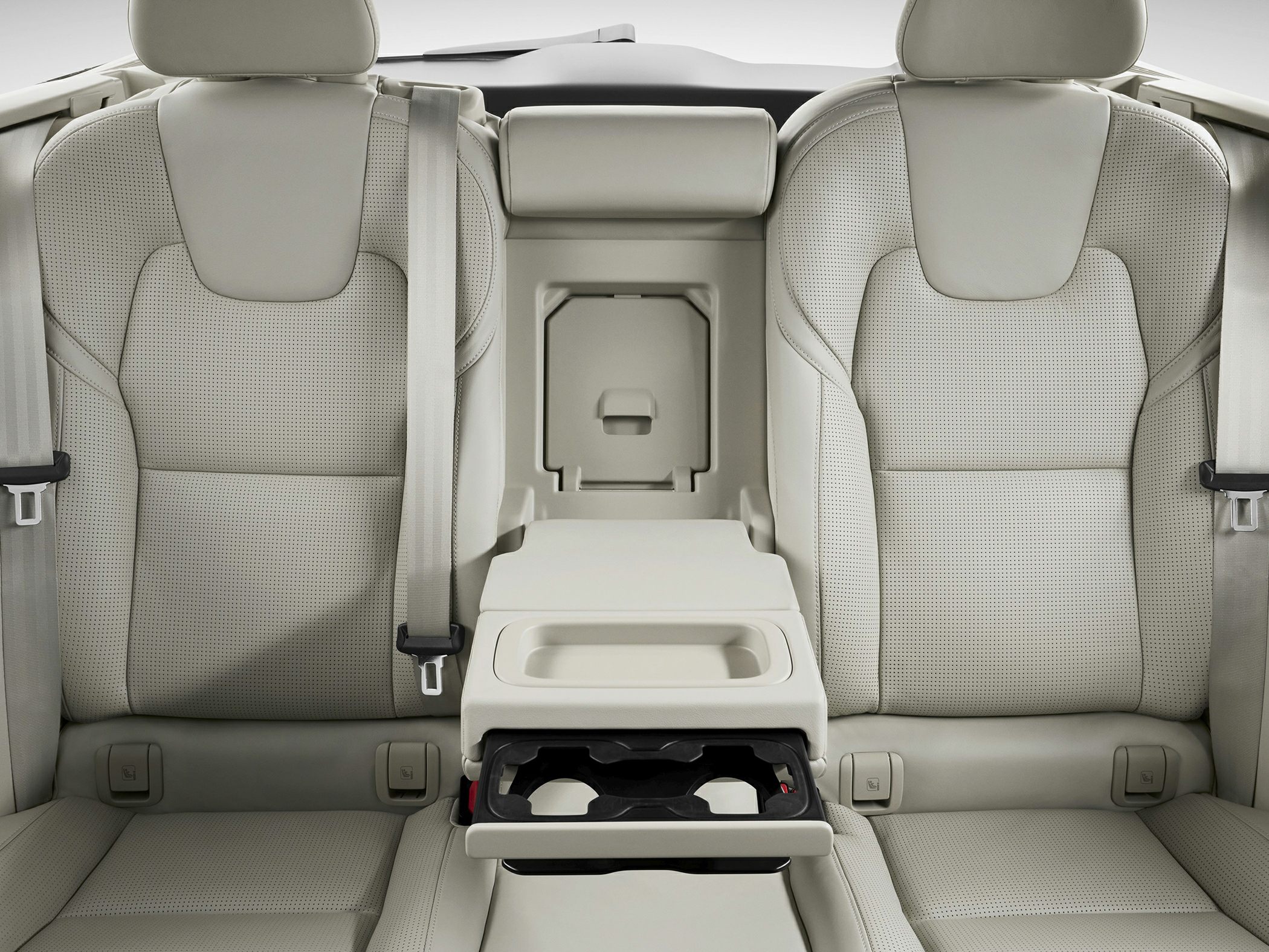 Perforated leather rear seats with center armrest and fold-out cupholders