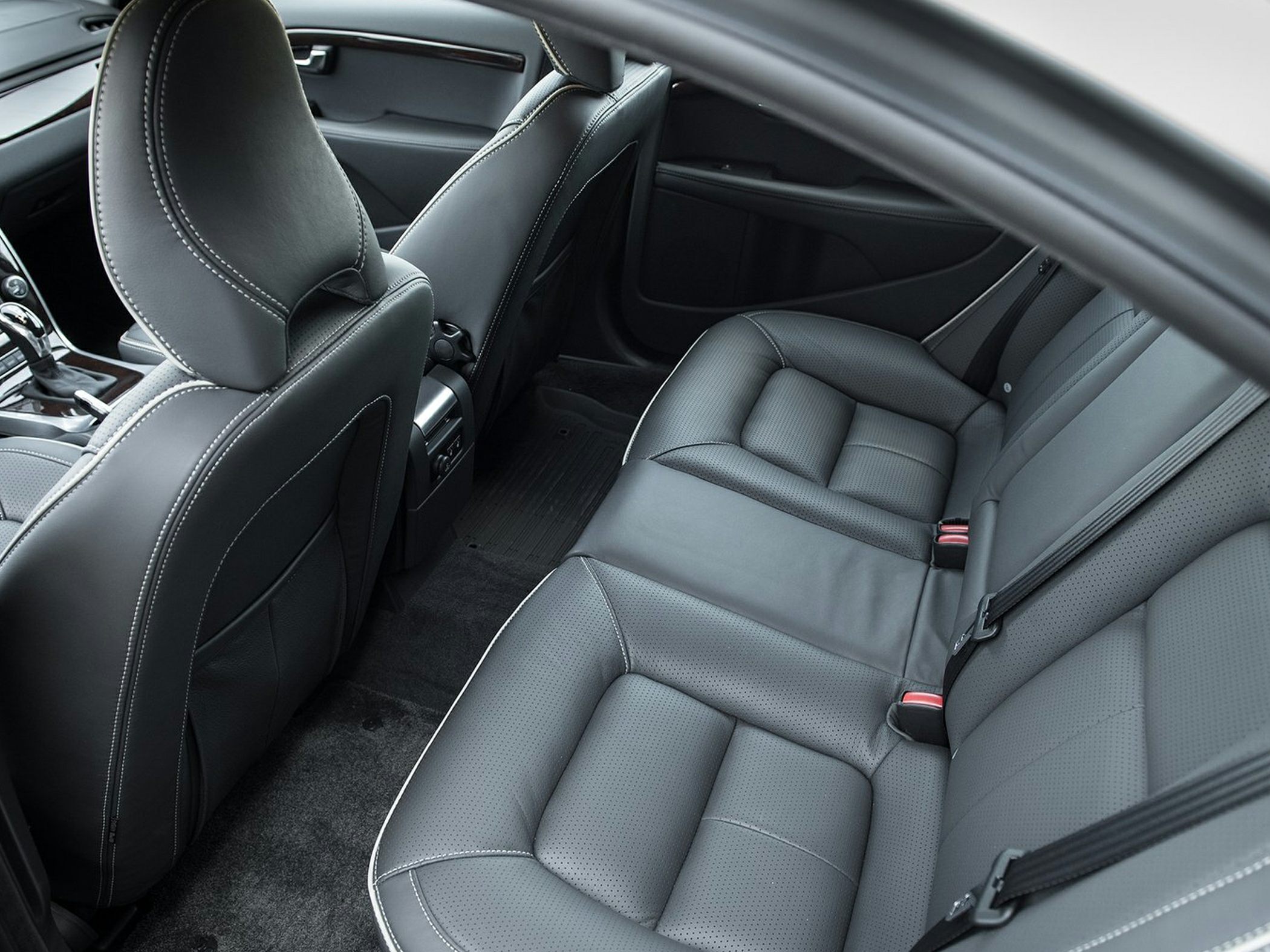 Rear black leather seats with stitching and spacious legroom