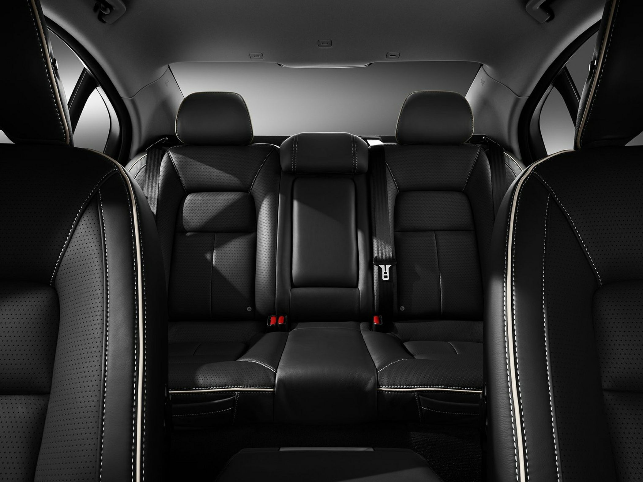 Rear black leather seats with detailed stitching and headrests