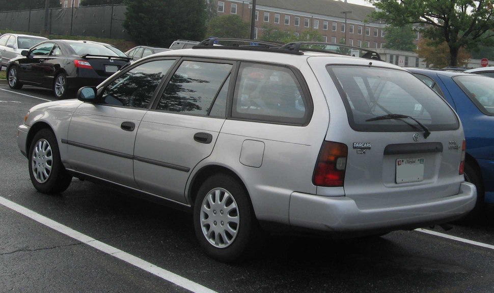 Rear and side profile of a classic 1990s station wagon with distinctive rear window and wheel cover design