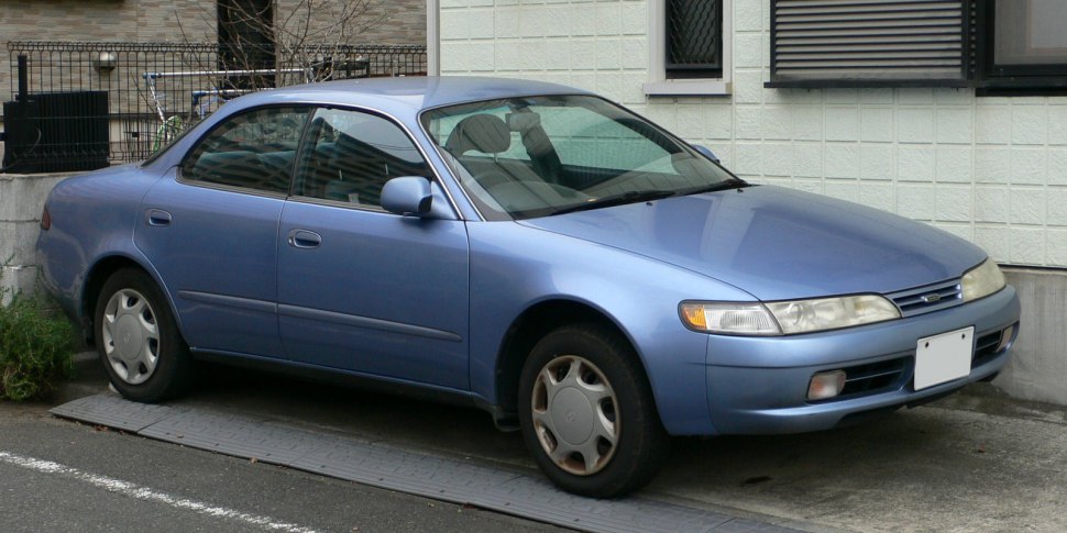 Side view of sedan with rounded headlights and aerodynamic smooth body.