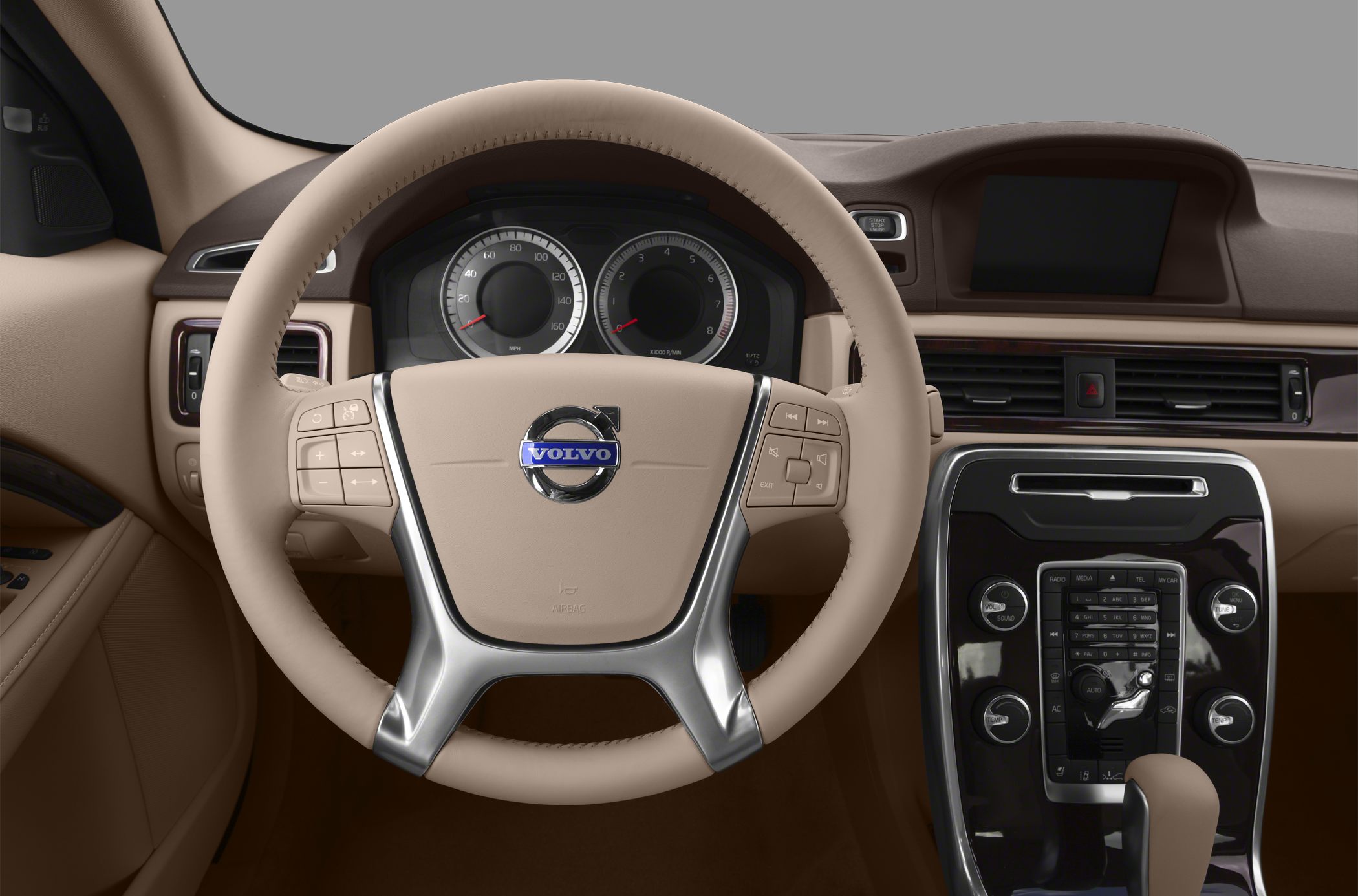 Beige steering wheel and dashboard with control buttons and central infotainment panel