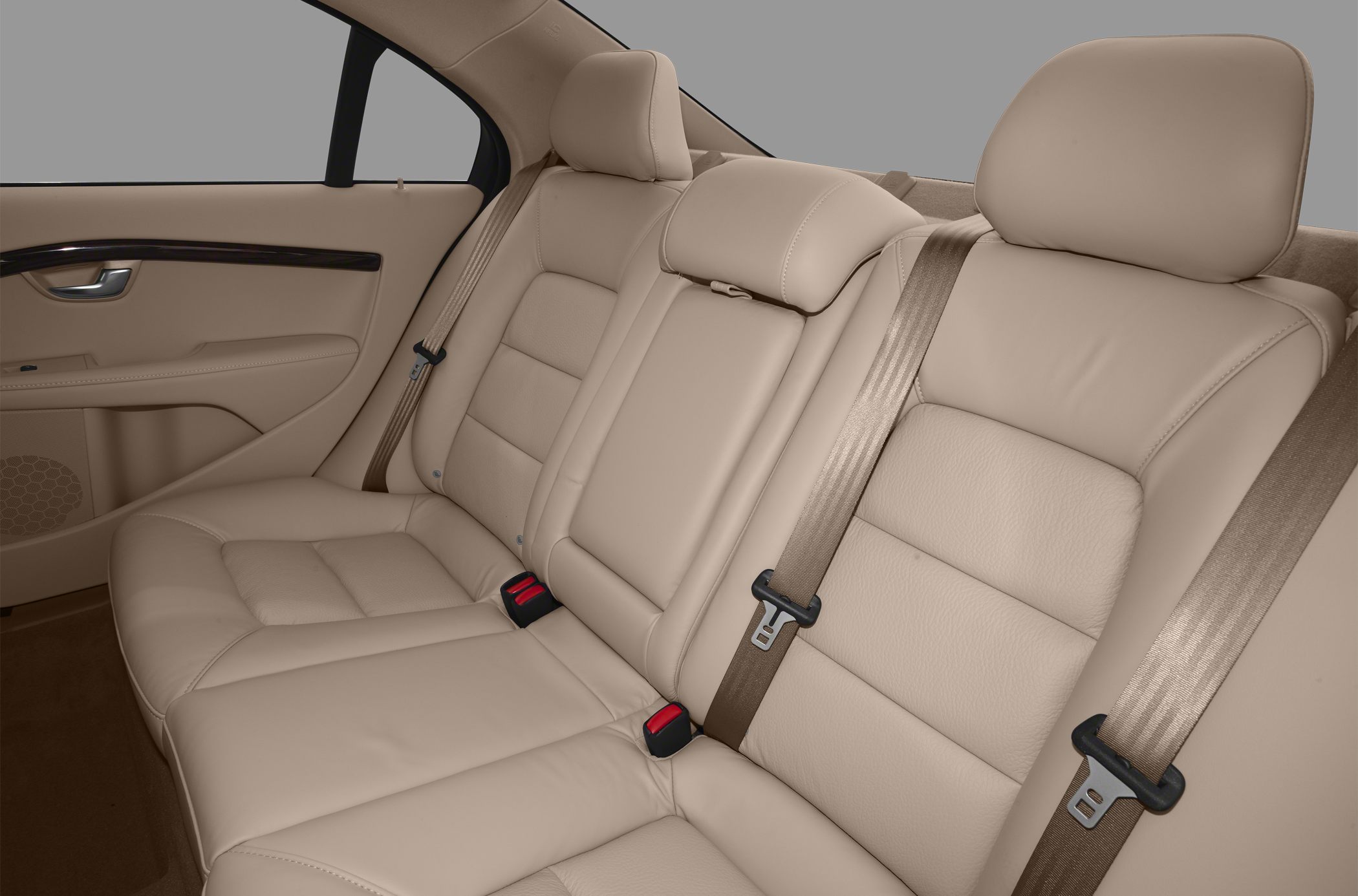 Beige leather rear seats with seat belts and headrests