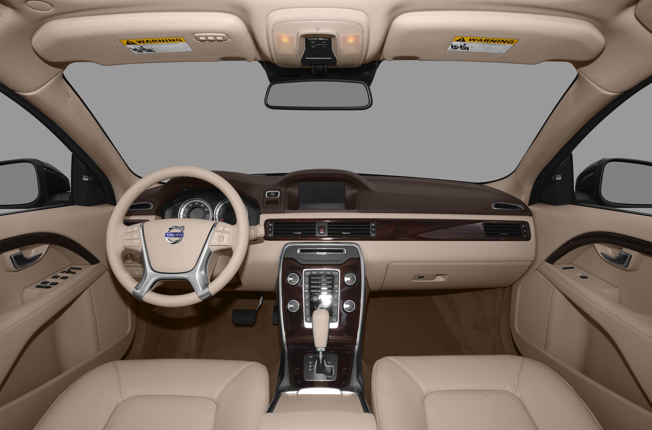 Beige interior with dashboard, steering wheel, wood trim, and central console