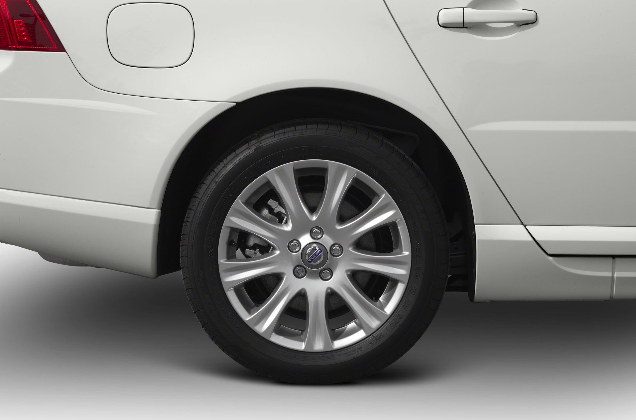 Rear alloy wheel and fuel cap close-up of a passenger sedan.