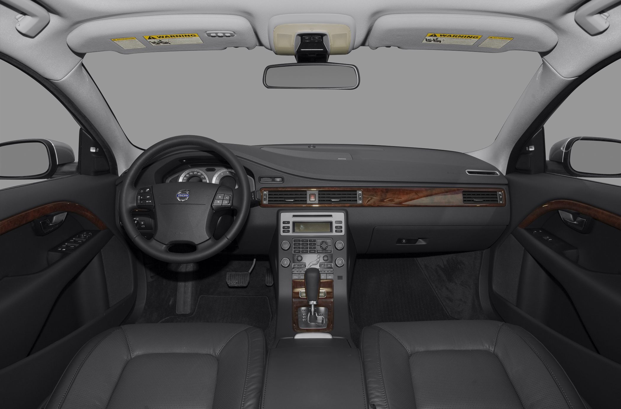 Luxury car interior with wood trim, leather seats, and digital dashboard controls