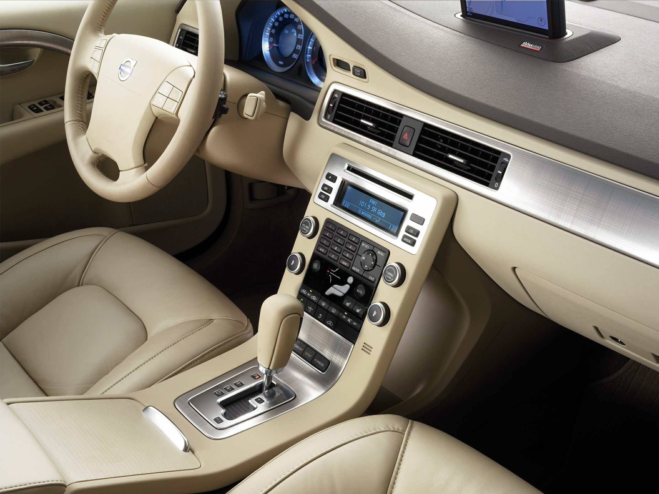 Beige leather interior with dashboard and center console featuring modern controls